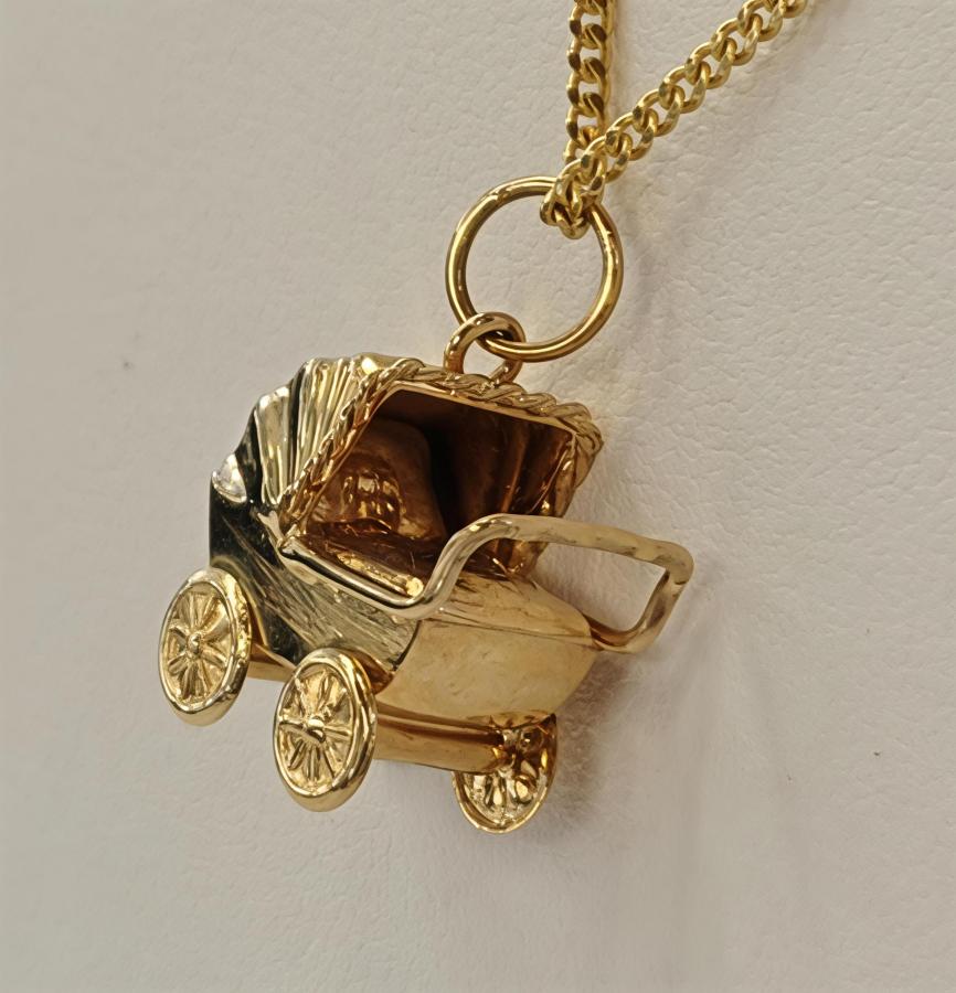 Kultainen maskottiriipus lastenvaunut